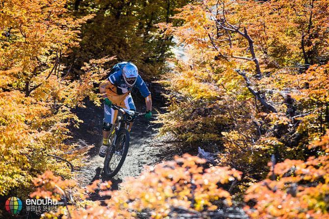A rider flies through the colorful Chilean landscape