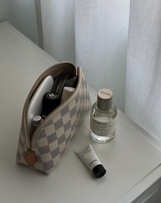 Beauty products on a table and in a bag.