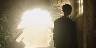 Jake Chambers looks into a portal in The Dark Tower