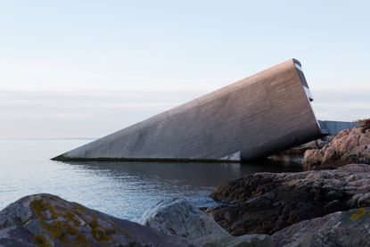 Breaking the surface of the water to rest directly on the seabed 5m below, Snohetta’s 34m-long monolithic building features a rough concrete shell designed to function as an artificial reef, welcoming limpets and kelp to inhabit it