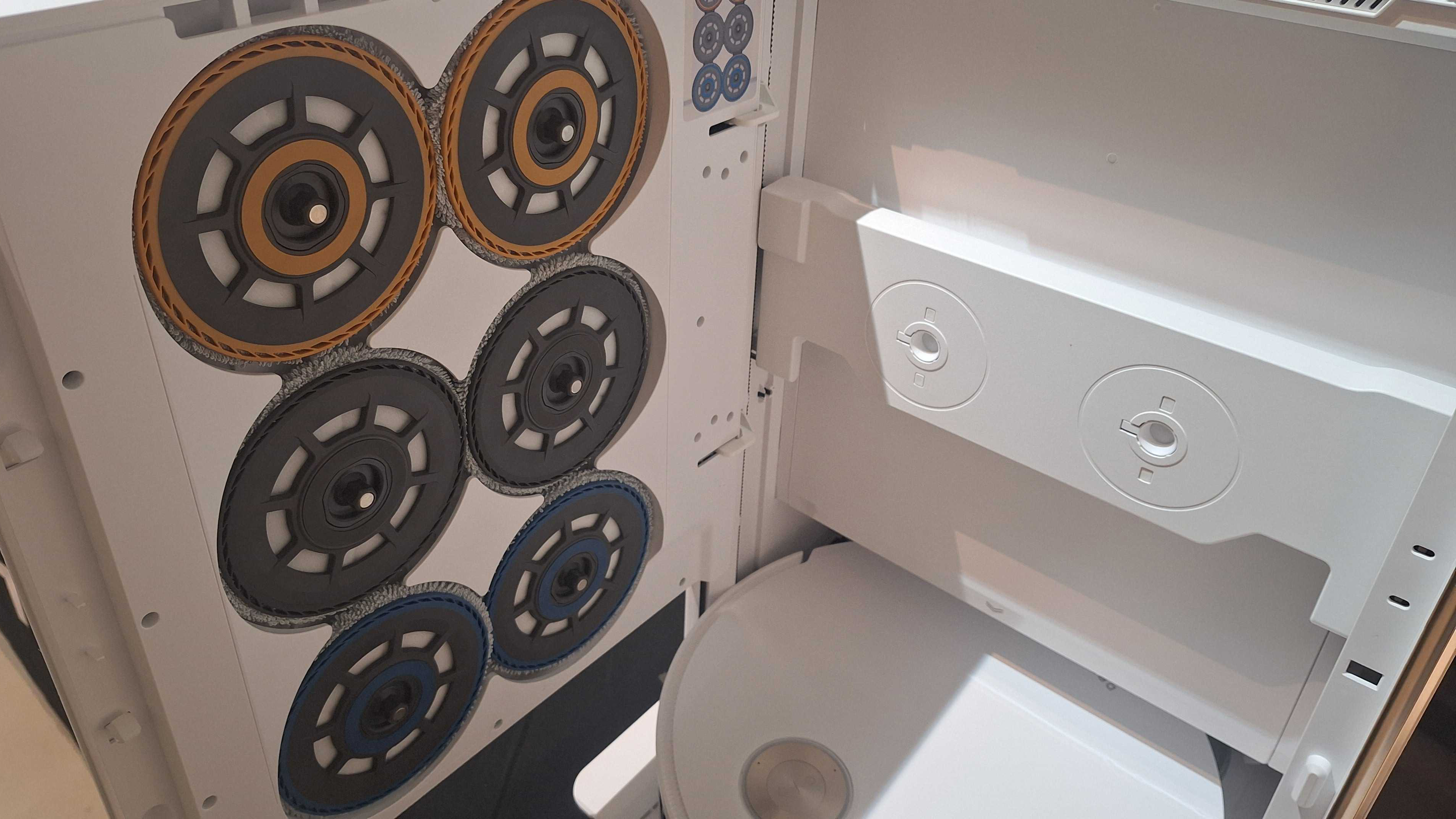Photo showing the Dreame Matrix10 Ultra&#039;s dock with the door open, revealing three sets of different mop pads