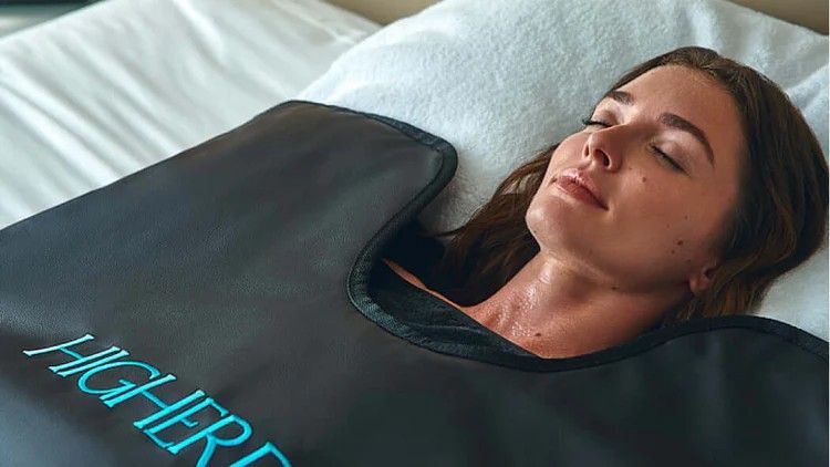 women using a sauna blanket 