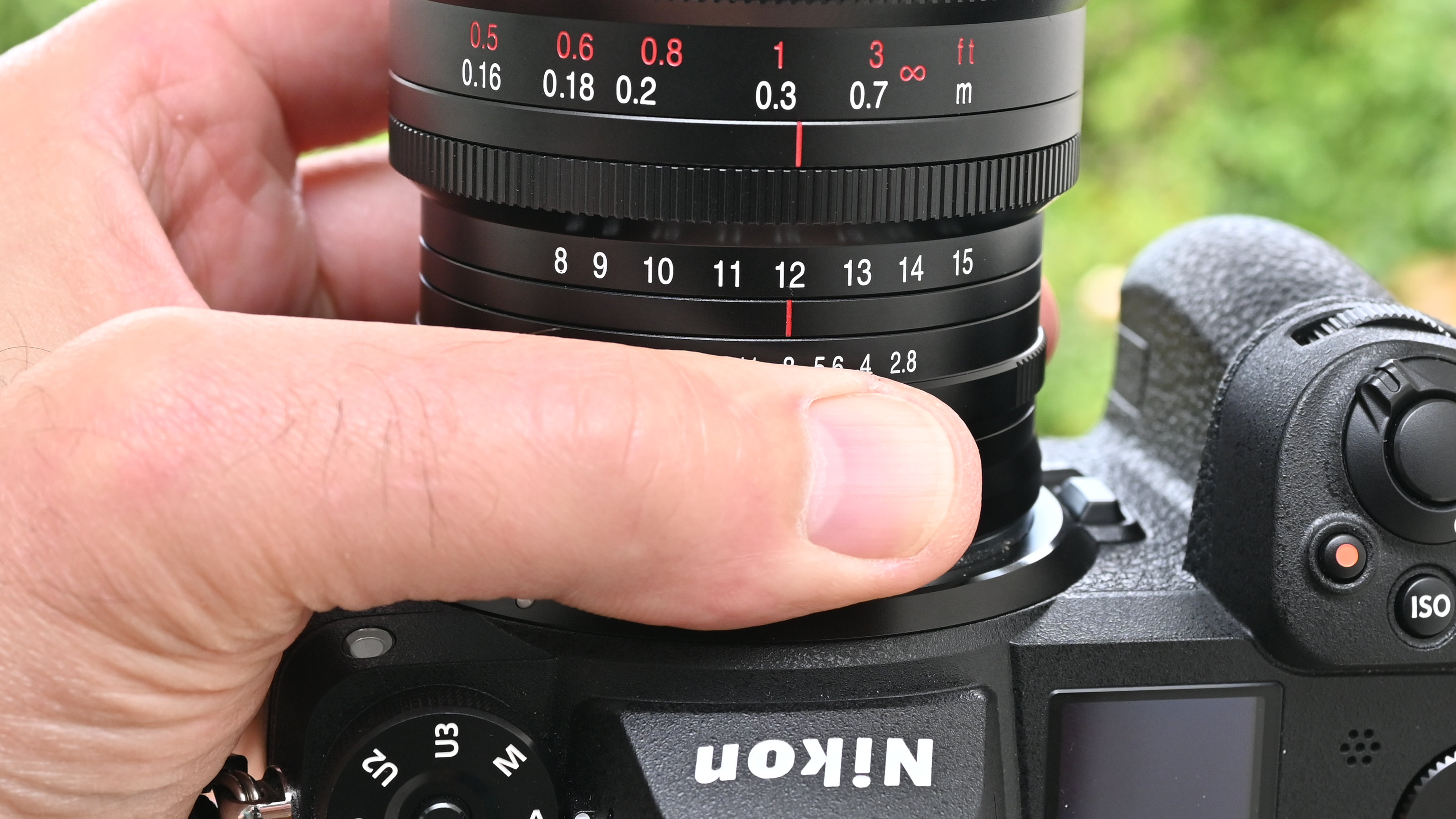 Laowa 8-15mm f/2.8 FF Zoom Fisheye product image of lens held in hand