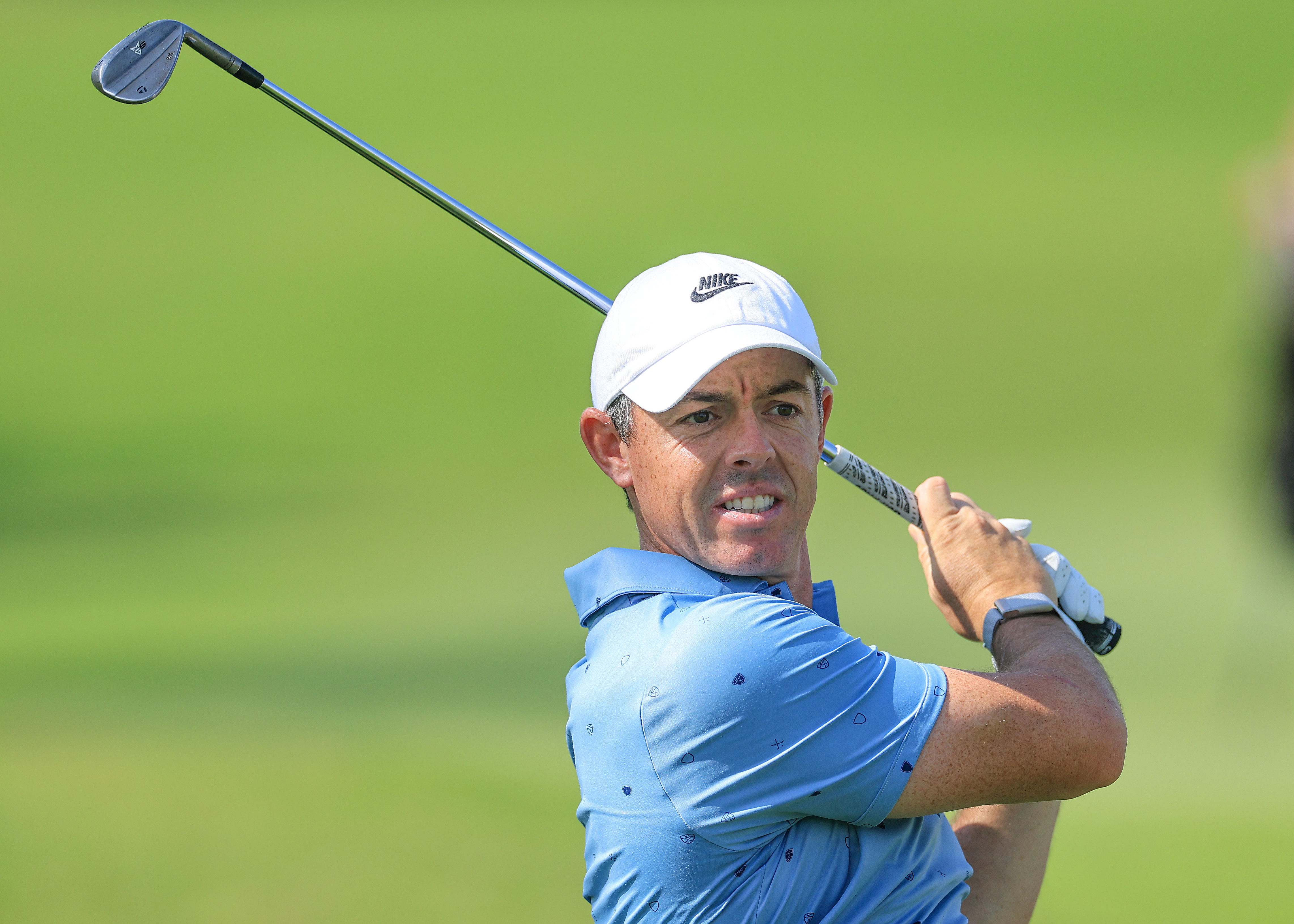 Rory McIlroy hits a wedge and watches its flight