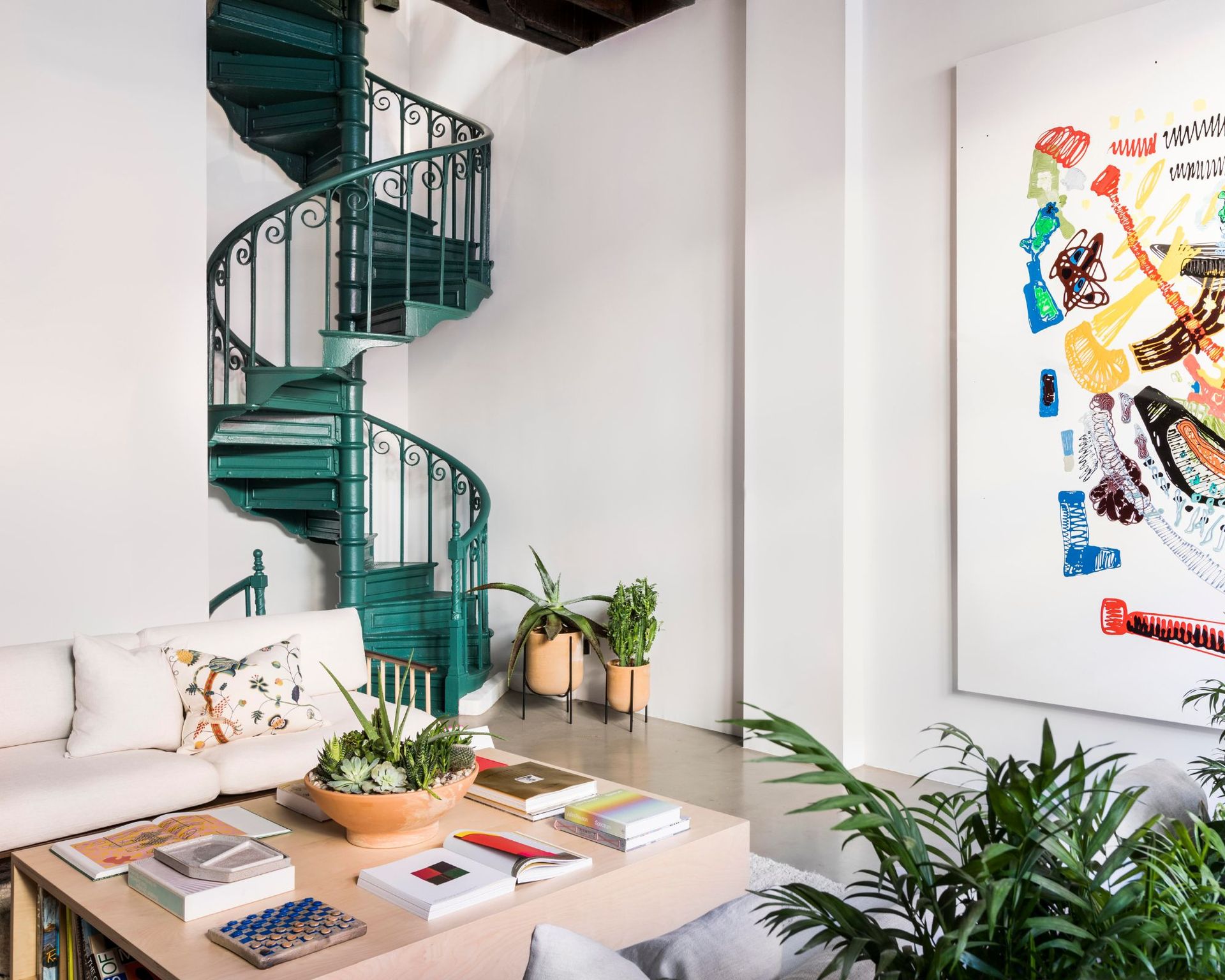 modern living room with dark green spiral staircase