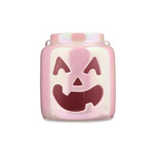 A shiny pink pumpkin face jar