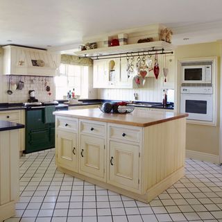 kitchen with tiles flooring and cabinets