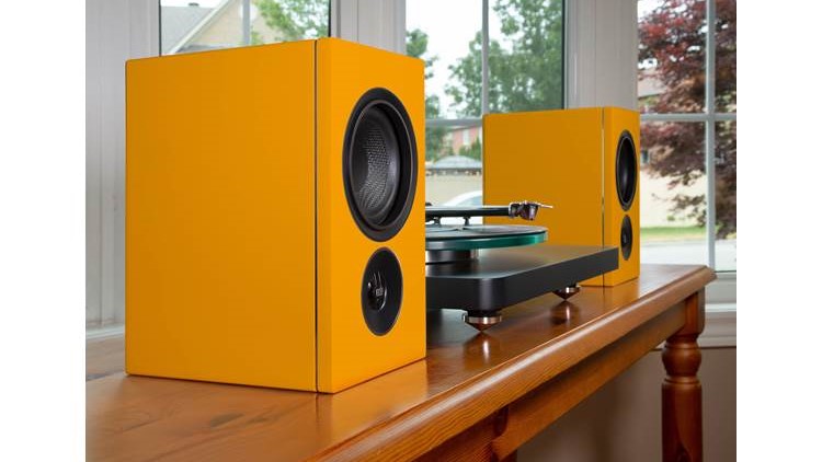 PSB Alpha iQ wireless speakers on table with turntable