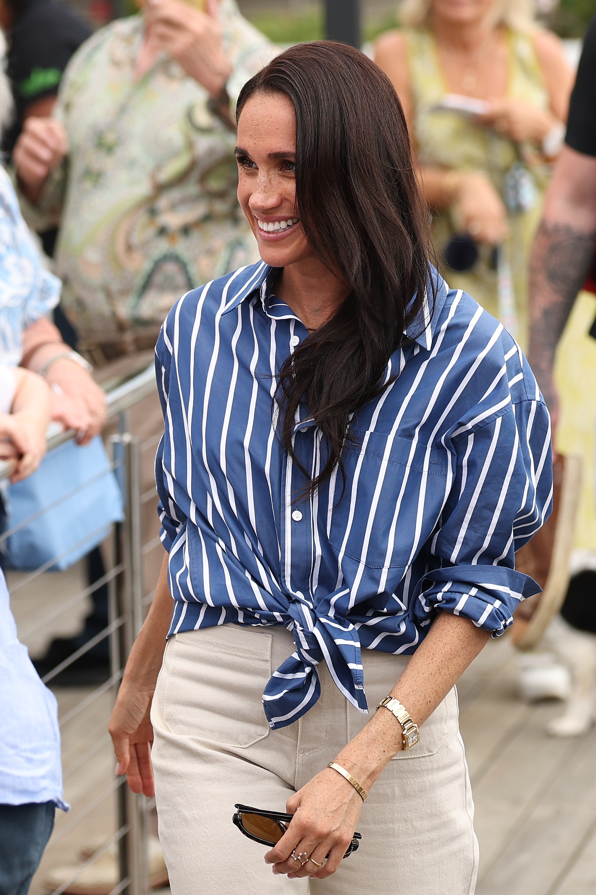 Meghan Markle wearing a blue striped shirt