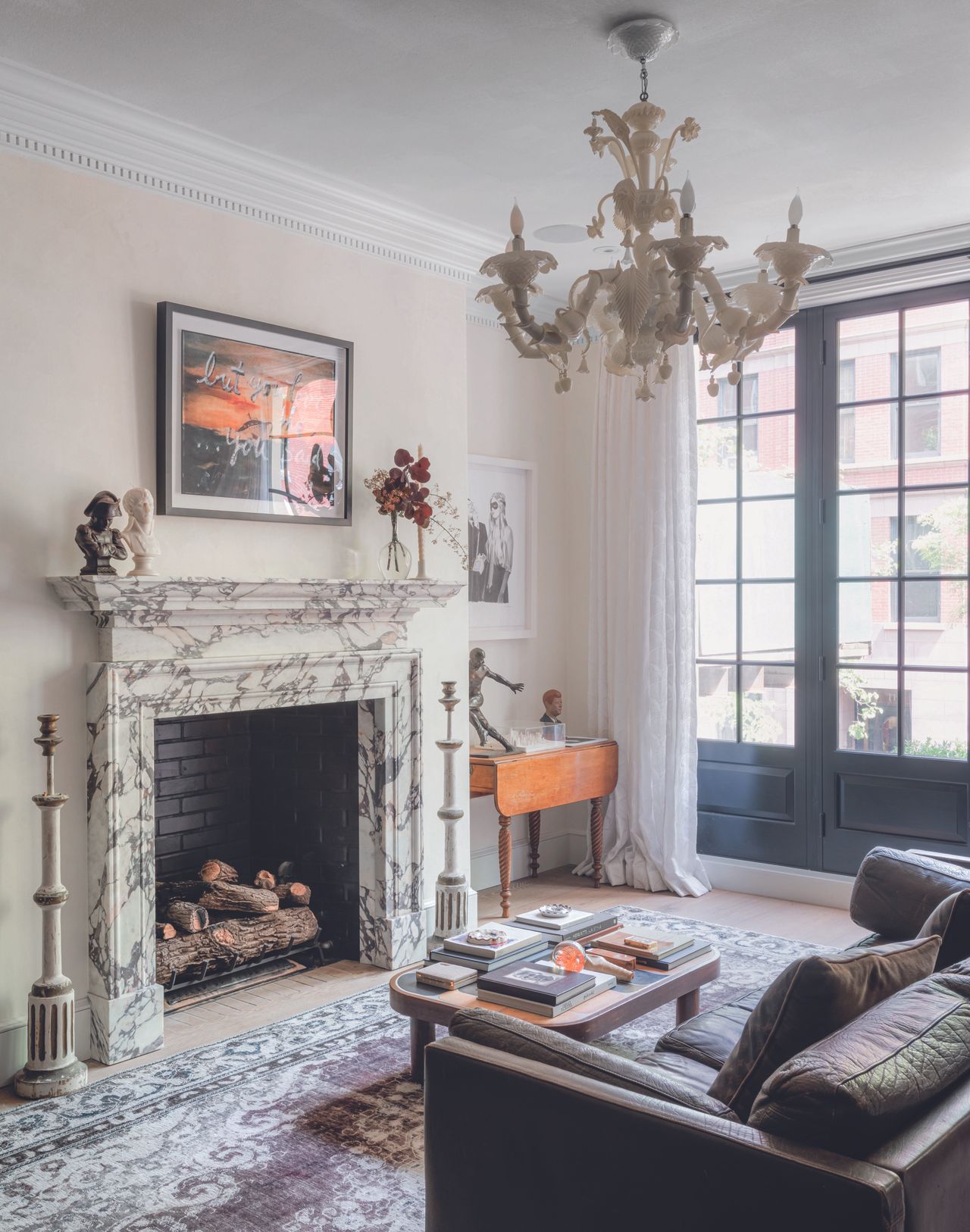 A seating area in the main bedroom with a fireplace