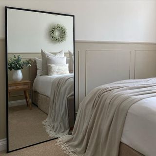 Neutral bedroom with large standing mirror