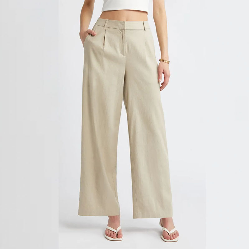 up close shot of Nordstrom model wearing beige trousers and white sandals