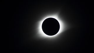 The total solar eclipse of Aug. 21, 2017. Here we see a black circle (the moon) with a ring of white light around it (the sun), all against a black background.