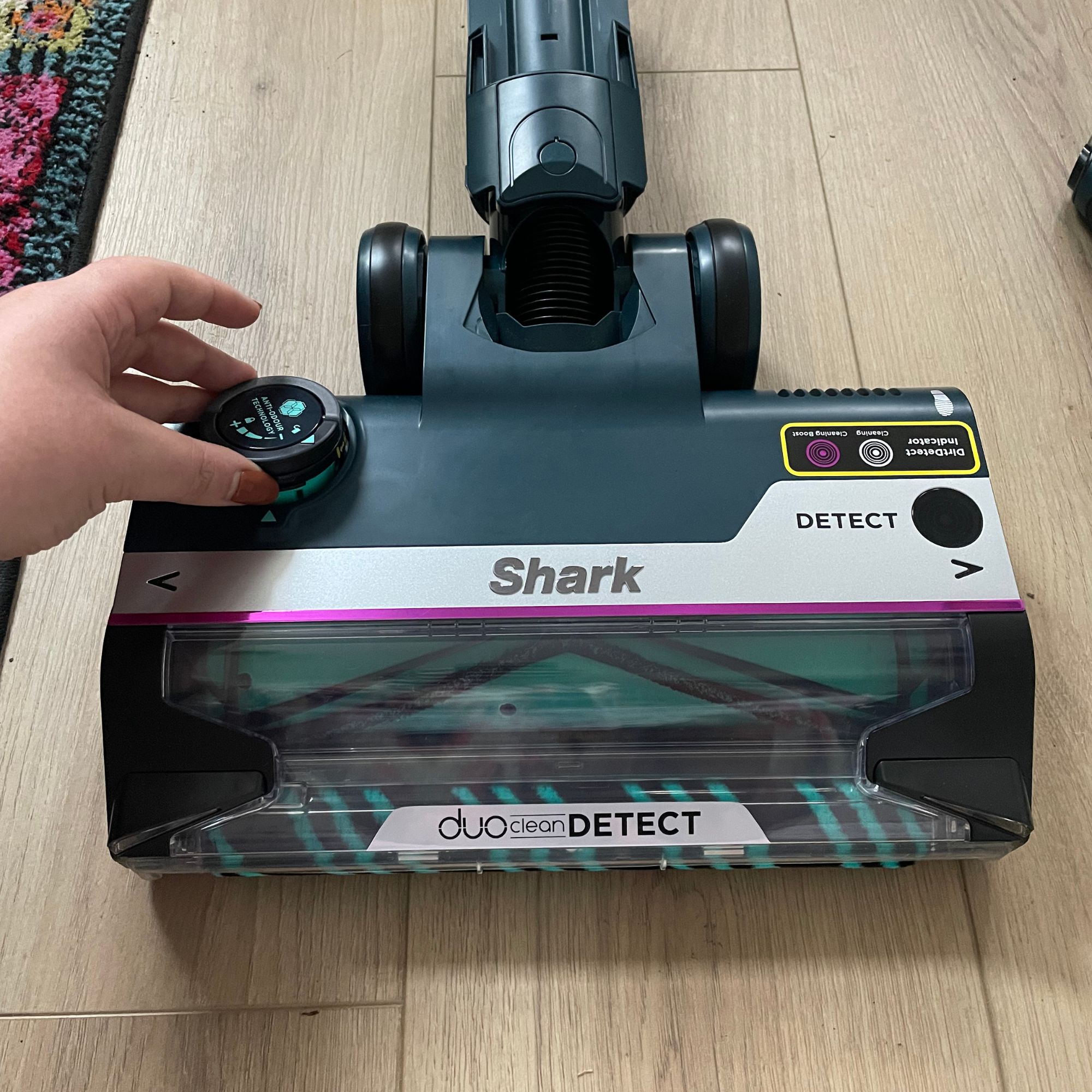 Hand placing the anti-odour cartridge into the floorhead of the Shark PowerDetect Powered Lift-Away Upright Pet Vacuum Cleaner AZ3900UKT