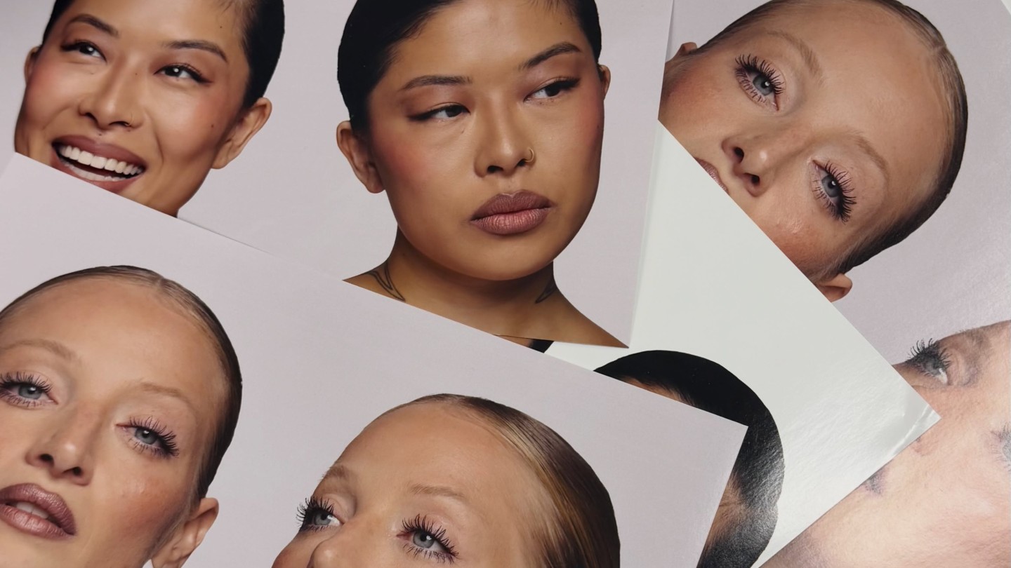 Photo of KJH.brand campaign images on a table