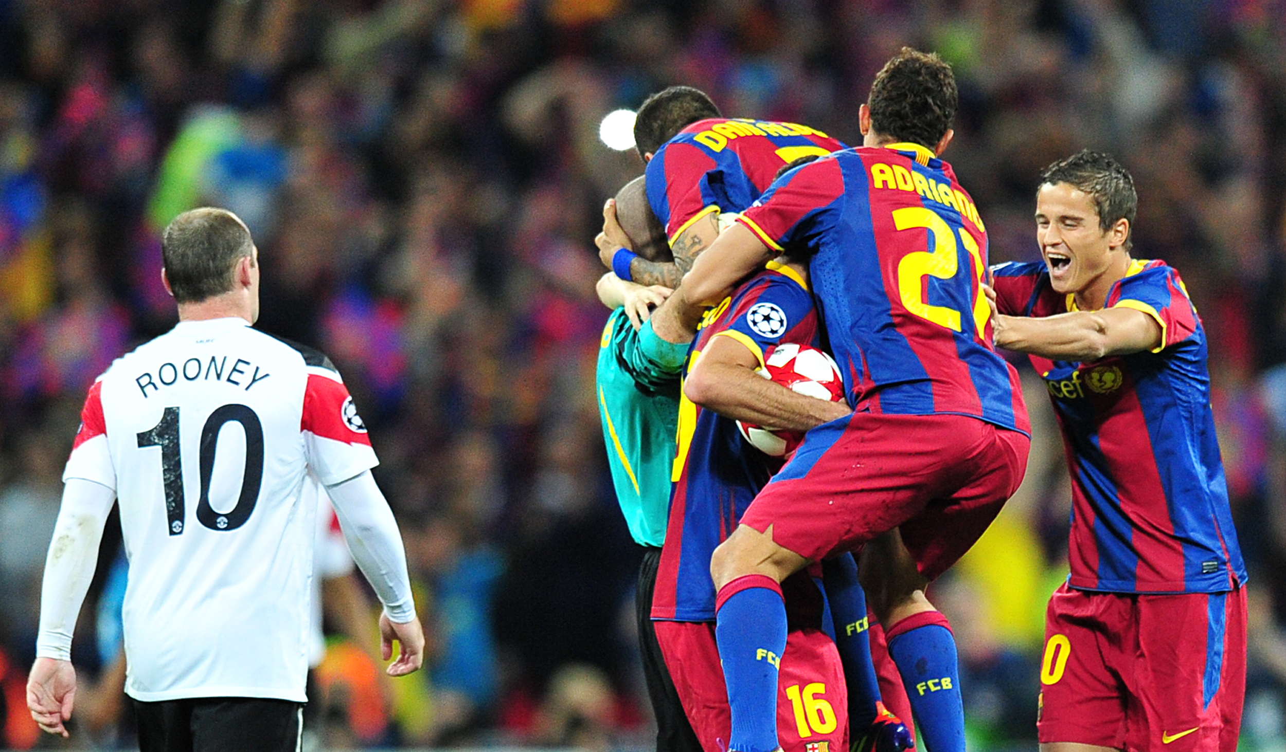 Barcelona players celebrate next to Manchester United's Wayne Rooney after the final whistle of the 2011 Champions League final at Wembley.