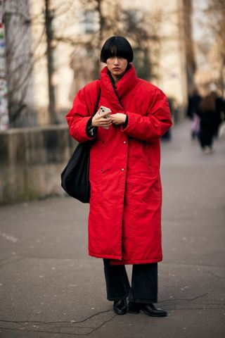 woman wearing a red coat in Paris Fashion Week