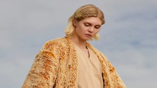 Woman in a golden fluffy jacket