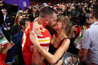 Travis Kelce #87 of the Kansas City Chiefs and Taylor Swift embrace after defeating the San Francisco 49ers in overtime during Super Bowl LVIII