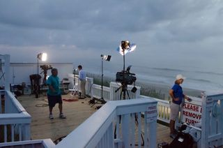 tv crew sets up to watch hurricane irene on the beach