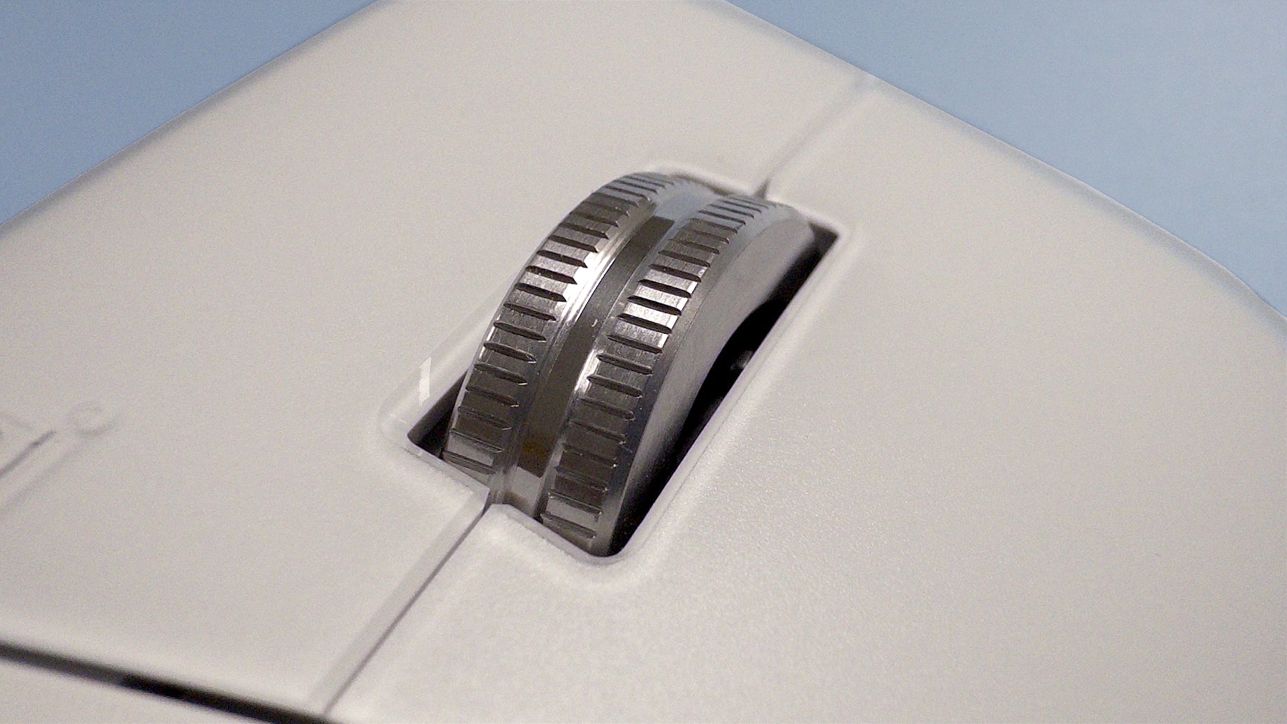 The Logitech MX Master 4 mouse against a blue background.