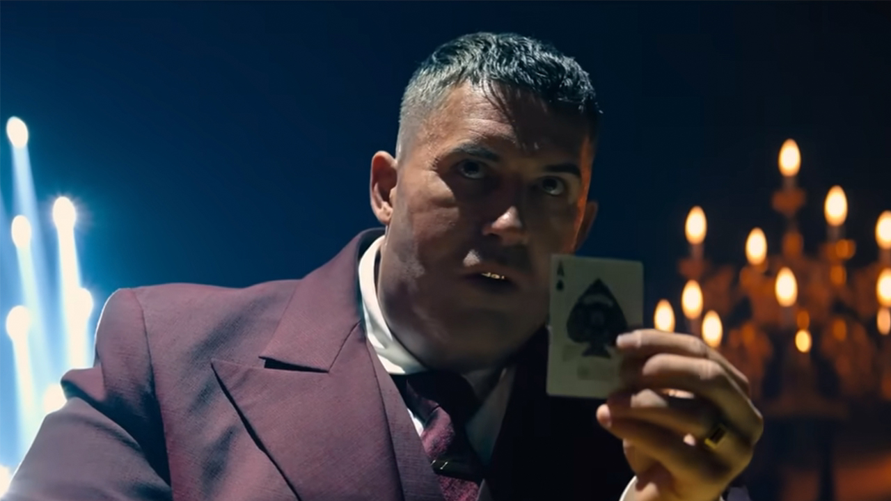 A man holding up the ace of spades in John Wick: Chapter 4