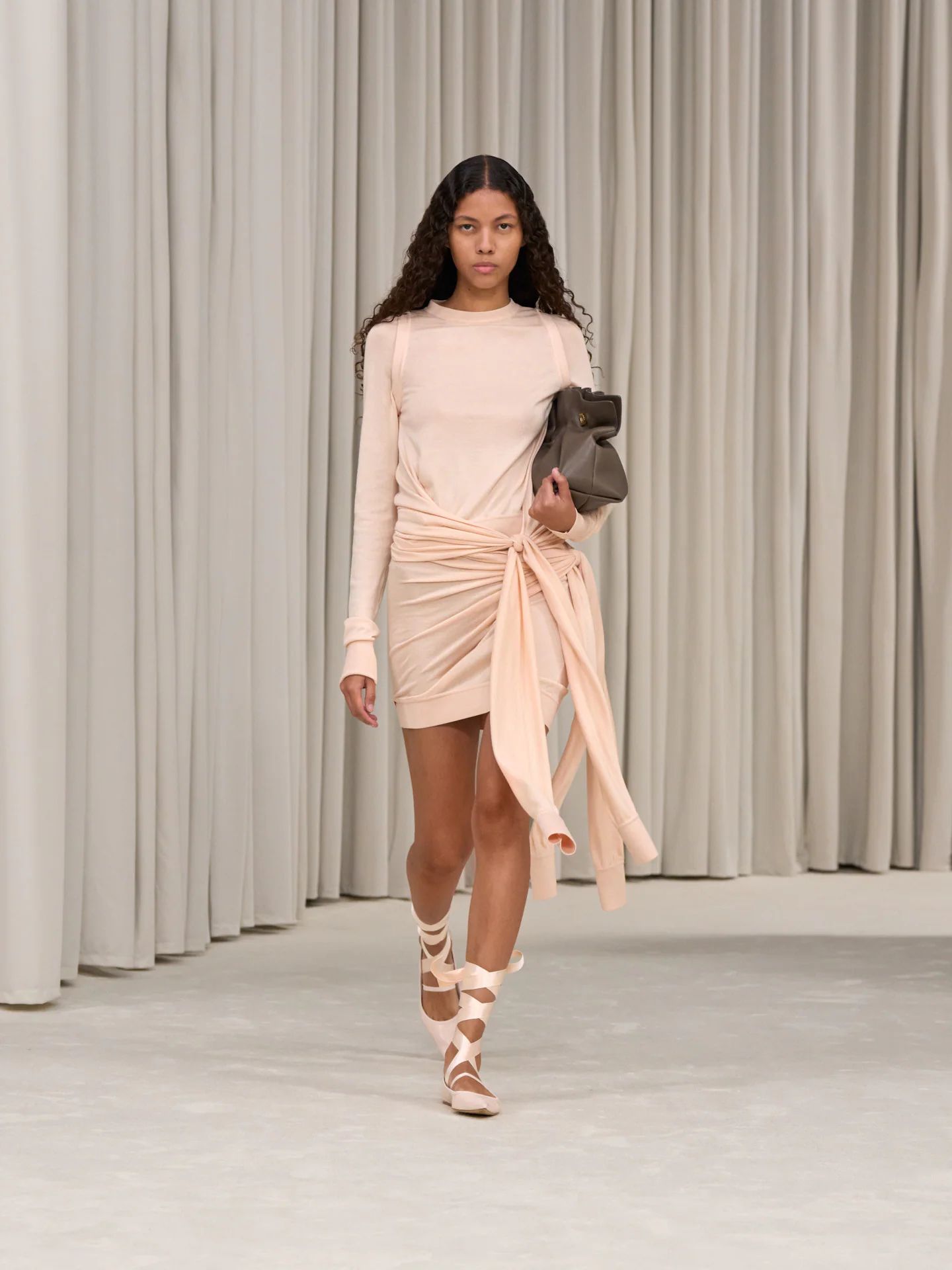 A runway look from Ferragamo S/S25, featuring the Soft-Bag.