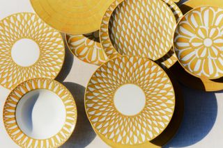 Yellow and white patterned plates laid out next to each other