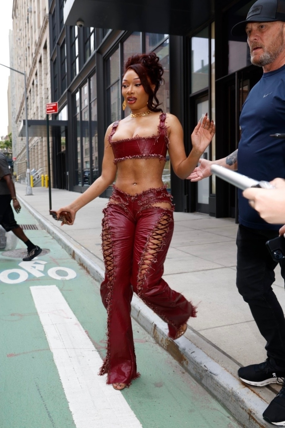 Megan Thee Stallion styled a burgundy bralette with lace-up cut-out leather pants during NYC's heatwave
