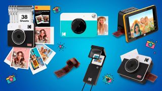 A selection of Kodak cameras and printers on a blue background.