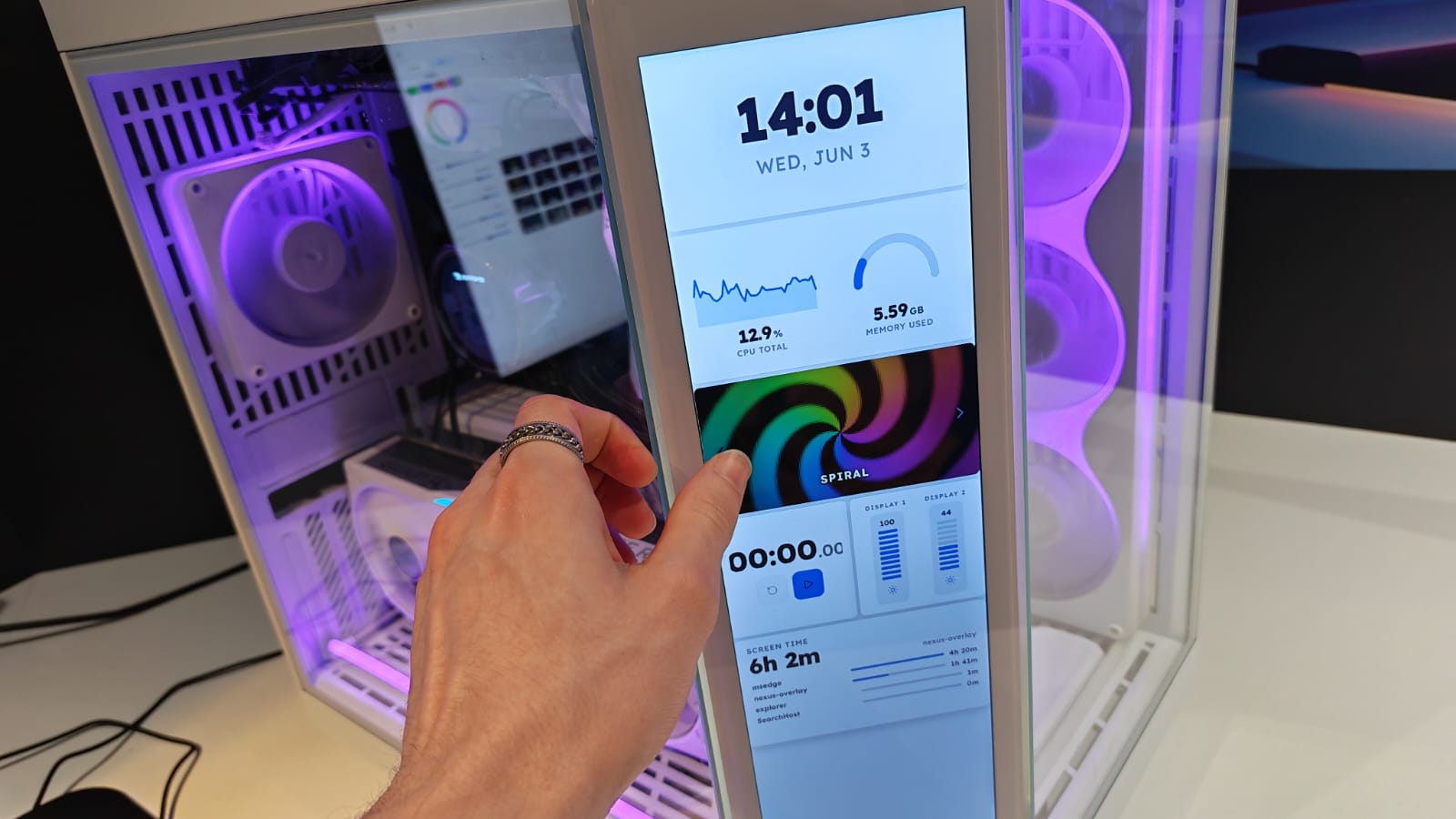 A reviewer reaching out to control an HYTE's PC touch display