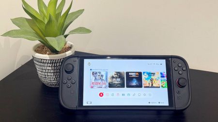 A Nintendo Switch 2 on a table showing icons for three Resident Evil games