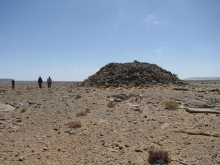 This large pile of rocks is called a "tumulus" by archaeologists. Researchers believe that it was likely used for a burial.