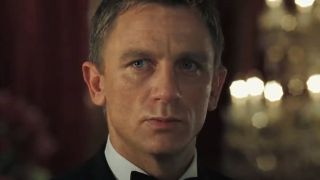 Daniel Craig stands staring ahead angrily in a hotel in Casino Royale.