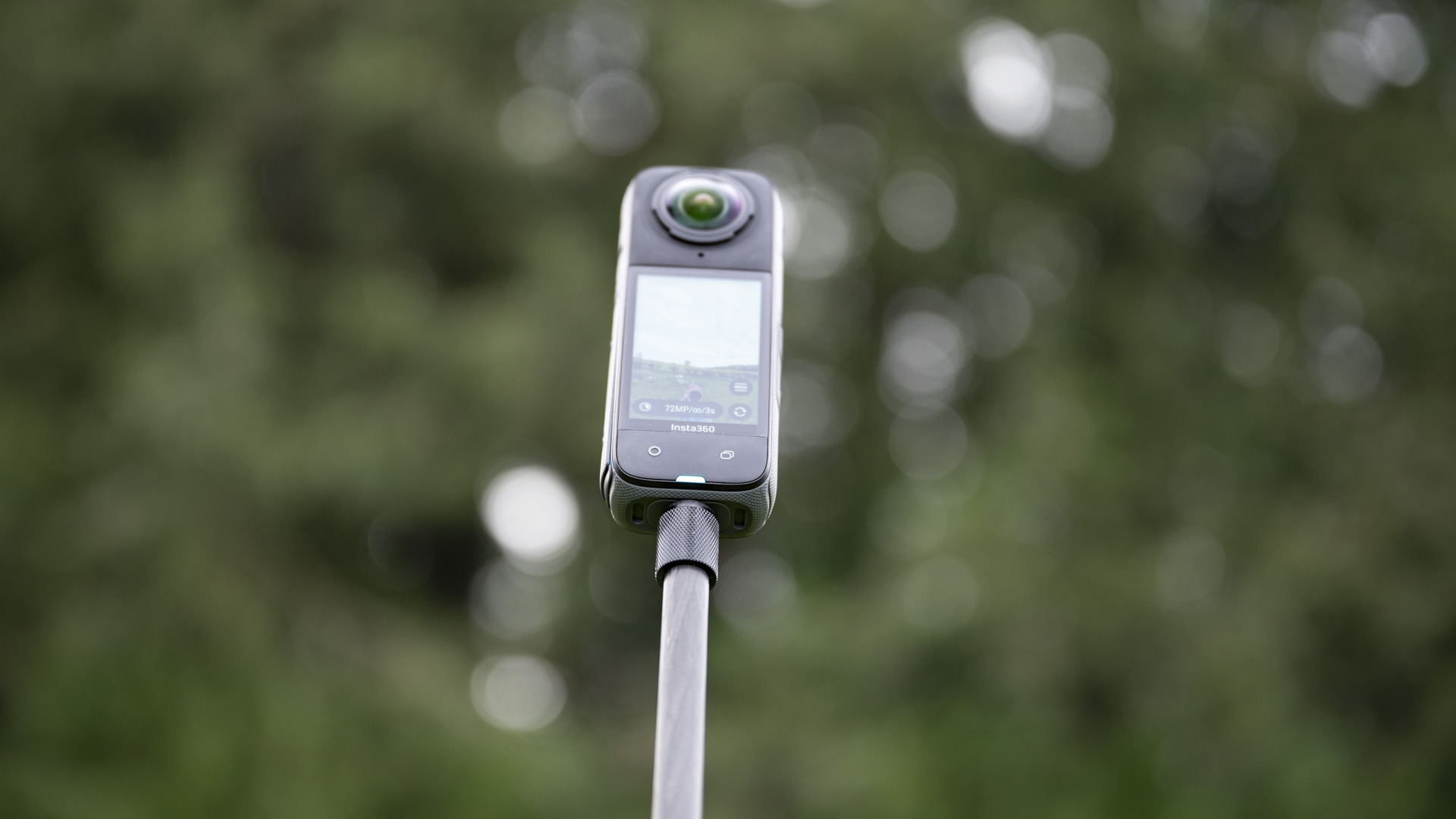Insta360 X4 360 degree camera on a selfie stick seen from way below