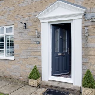 a composite door open on a stone house