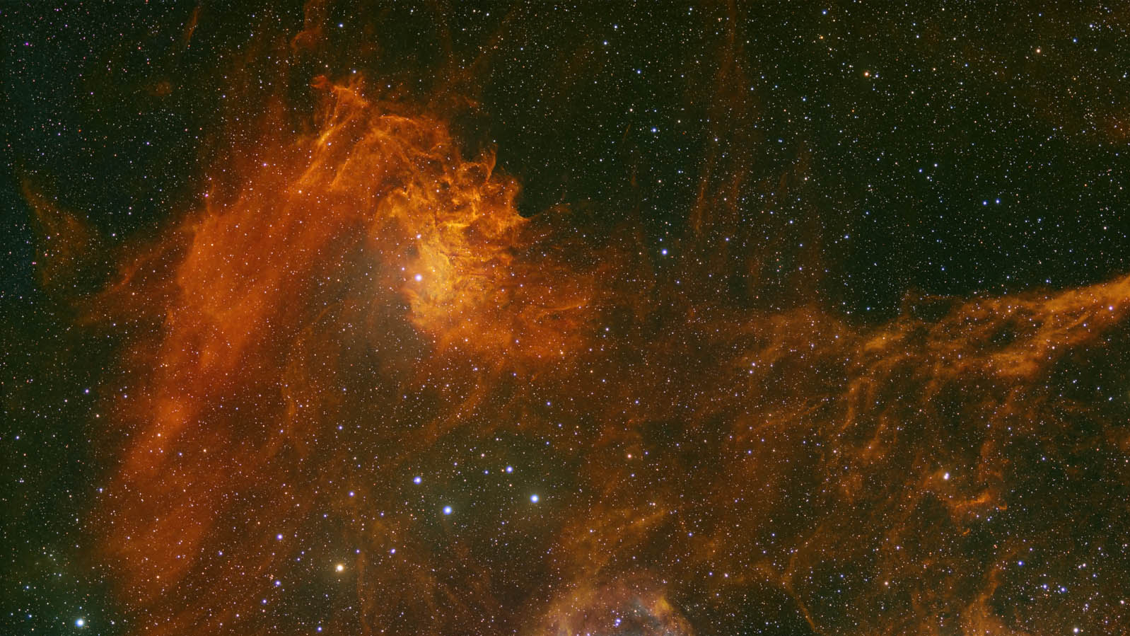 Swirls of red and orange gas fill a deep space starry background