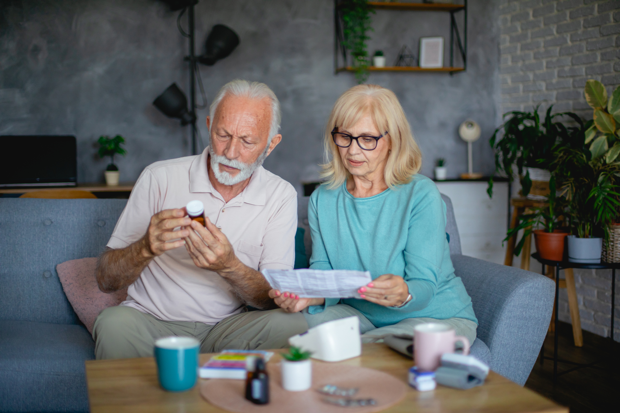 Senior couple reading label on prescription medicine