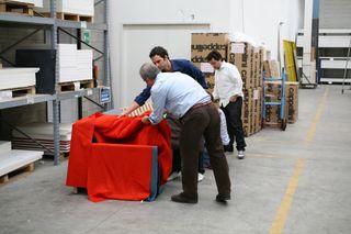 Barber Osgerby and Giulio Cappellini with sofa in warehouse
