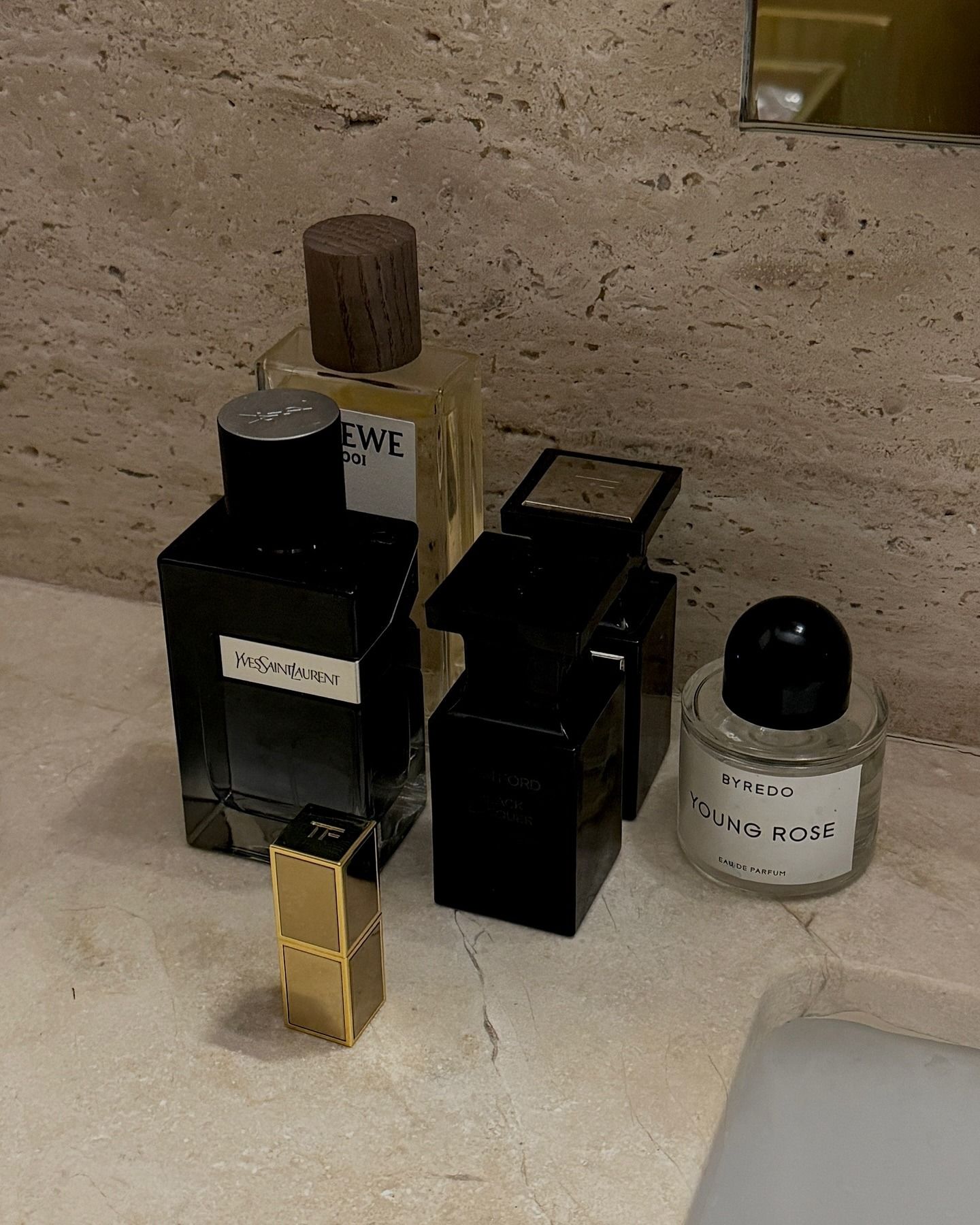 Photo of fragrances sitting on a bathroom sink