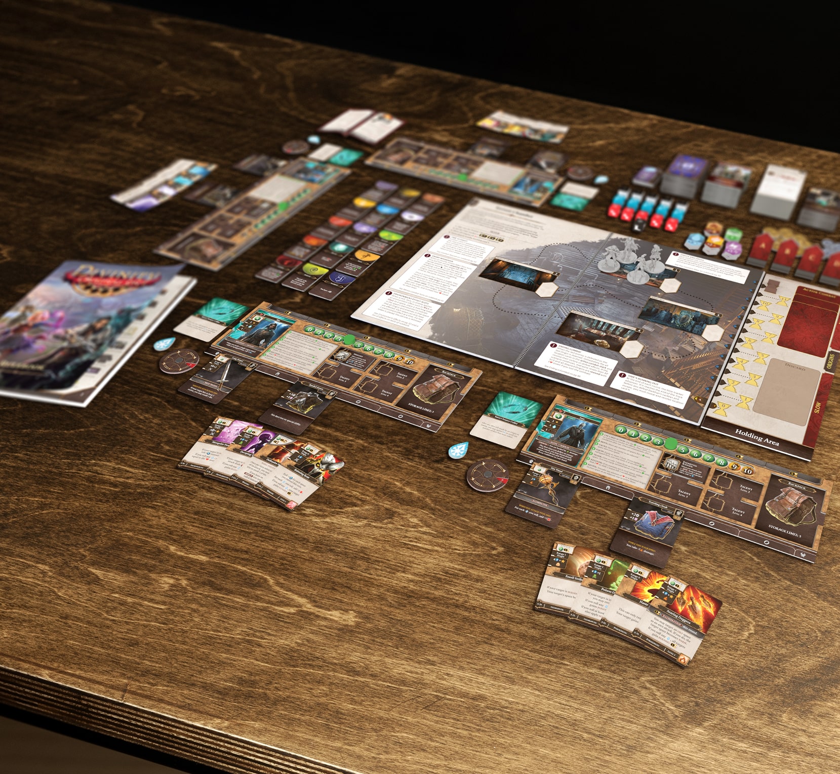 The components of the Divinity: Original Sin board game laid out on a table.