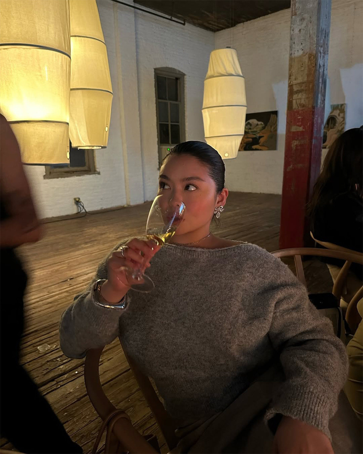 Allison Ho with a slicked-back bun and glowy skin