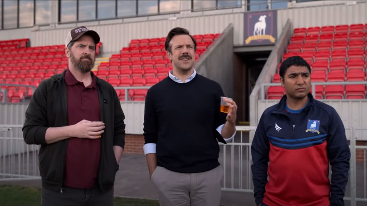 Ted Lasso, Coach Beard and Nate the Great watching a training session