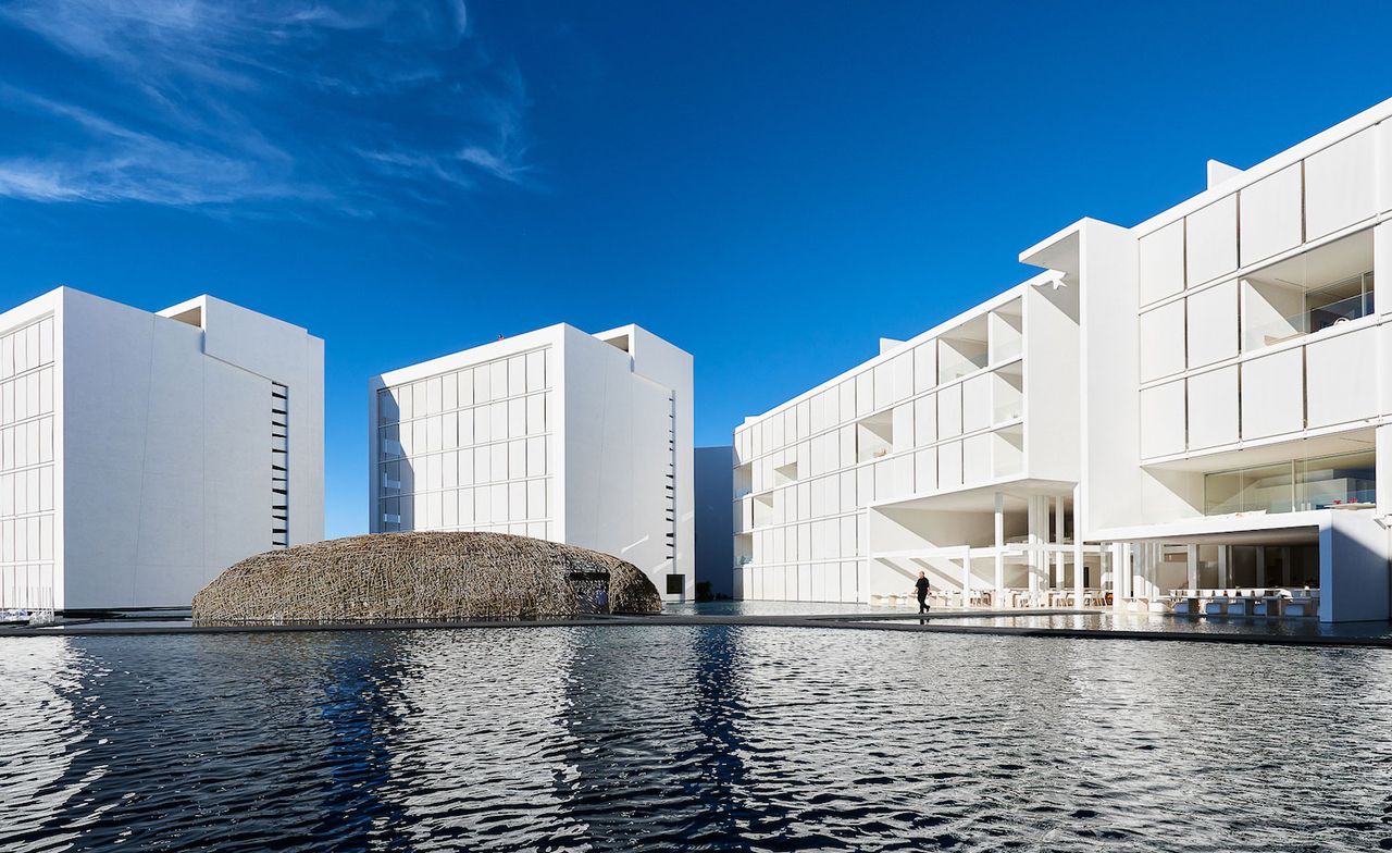 Exterior of Hotel/Residence with water feature and building white square design