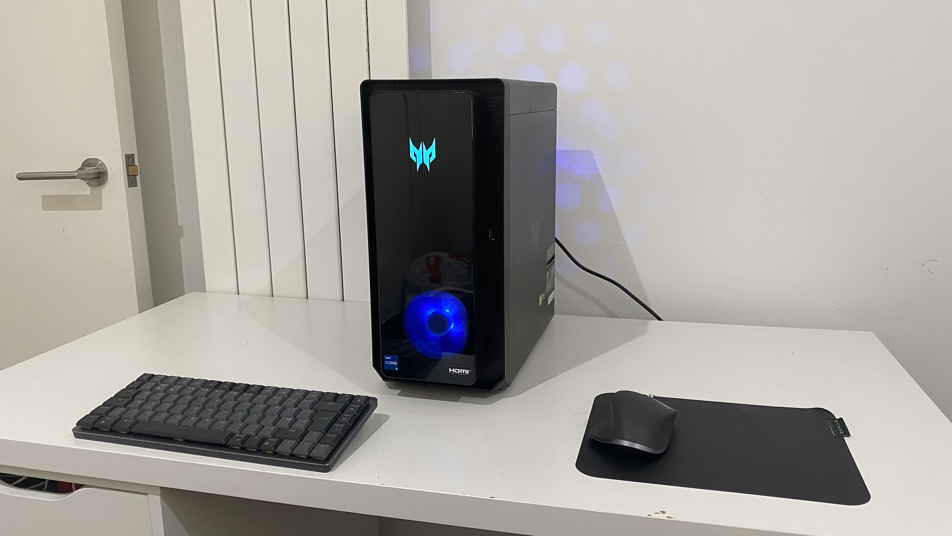 Acer Predator Orion 3000 desktop gaming PC on a desk with RGB lighting turned on.