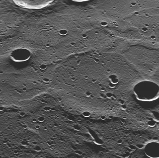 This photo of Mercury from orbit from NASA's Messenger spacecraft reveals never-before-seen terrain as it appeared on March 29, 2011. The newly imaged surface is located in Mercury's north polar region, to the north of the bright, rayed crater Hokusai. L