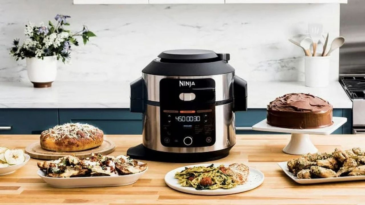 Ninja vs Ninja Foodi a Ninja Foodi Multicooker on a table with various foods surrounding it