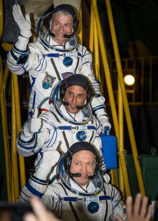 Expedition 53 flight engineers Mark Vande Hei (top) and Joe Acaba, and Soyuz Cmdr. Alexander Misurkin (bottom) wave farewell before boarding their Soyuz MS-06 spacecraft for launch from the Baikonur Cosmodrome in Kazakhstan on Wednesday (Sept. 13)