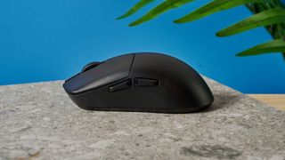 A black Lemokey G1 wireless gaming mouse sitting on a marble slab