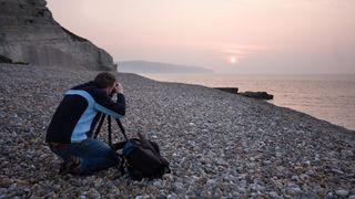 Photographer photographing on the beach at sunset